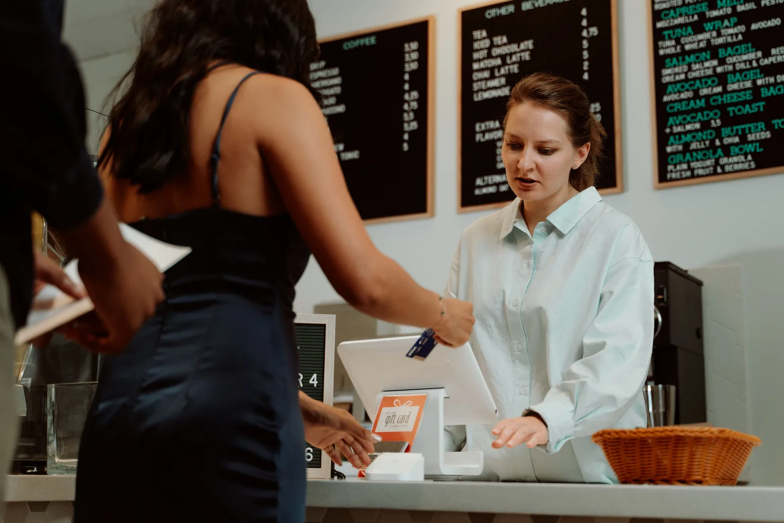 A customer paying by card at a counter