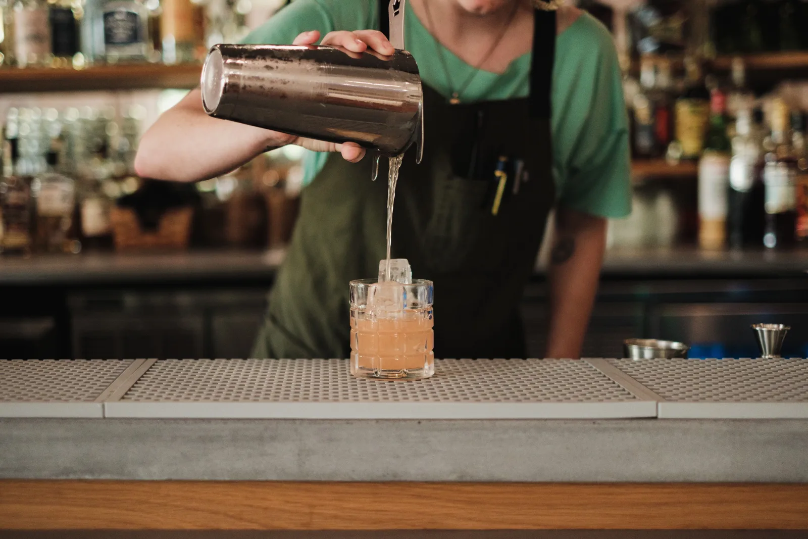 Bartender serving guests at a bar