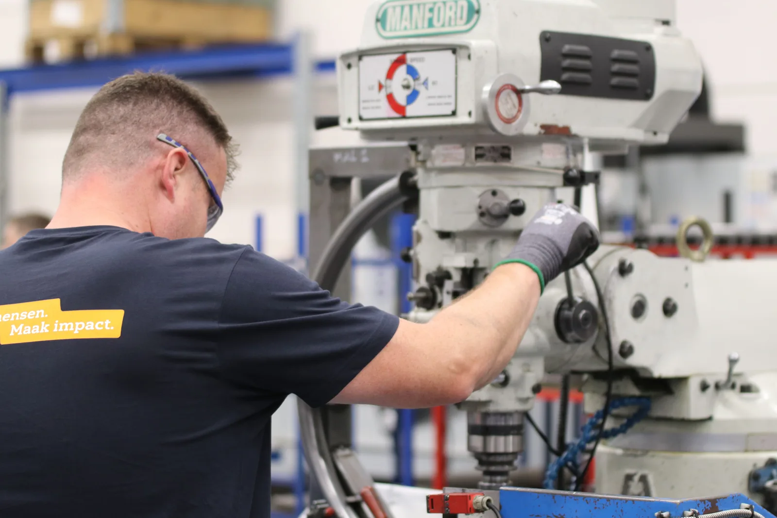 Machinist operating a milling machine in a manufacturing shop
