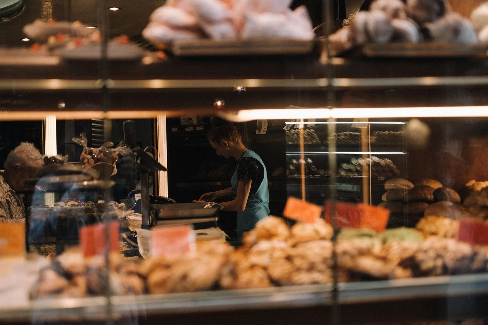 Staff working behind the pastry counter of a small neighborhood bakery