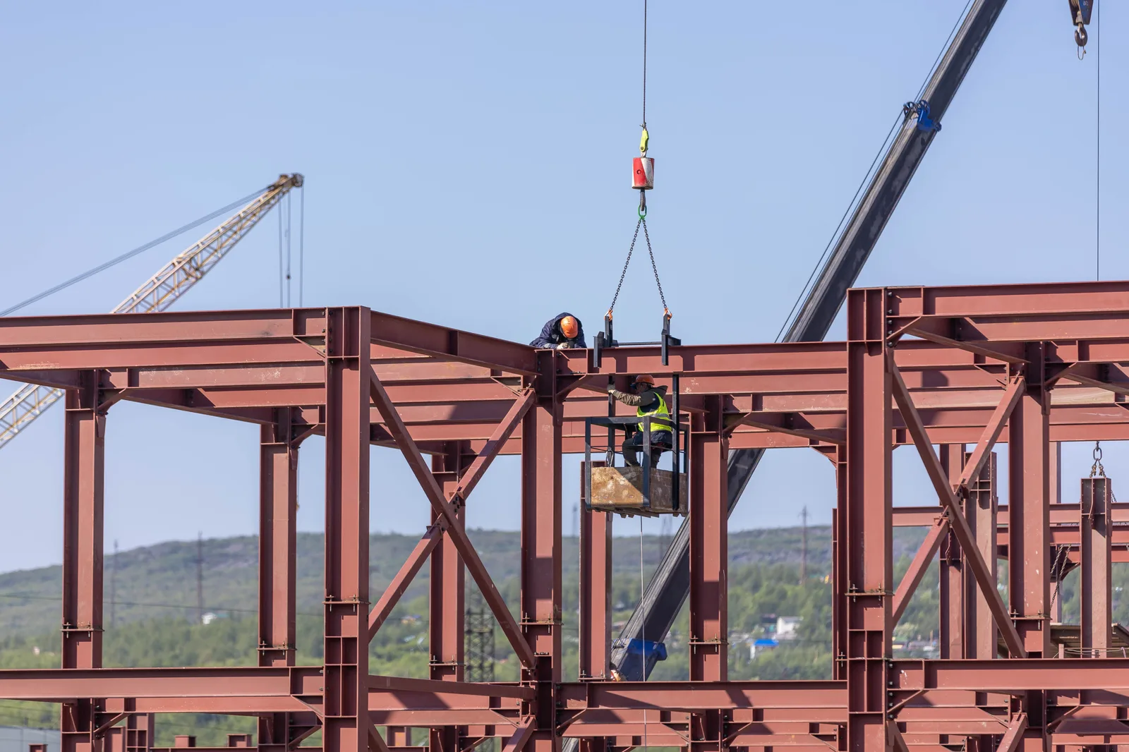 A construction crew working on a steel-framed commercial building