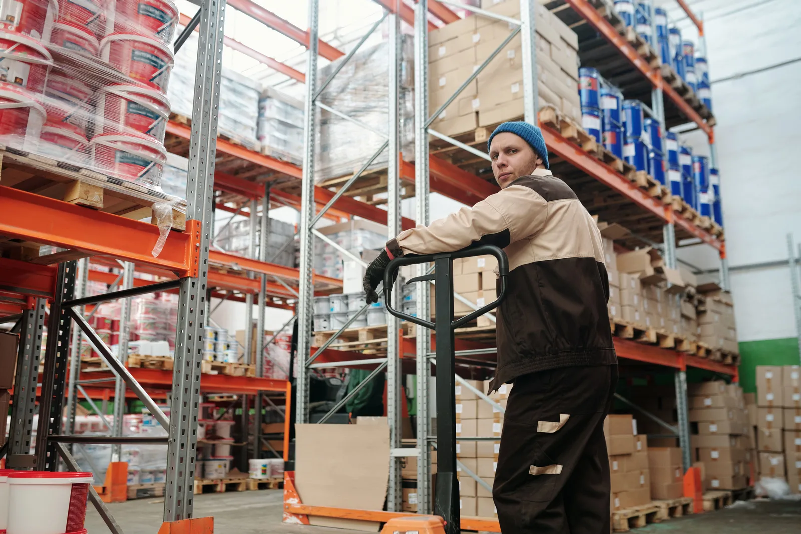 Warehouse worker moving inventory with a pallet jack