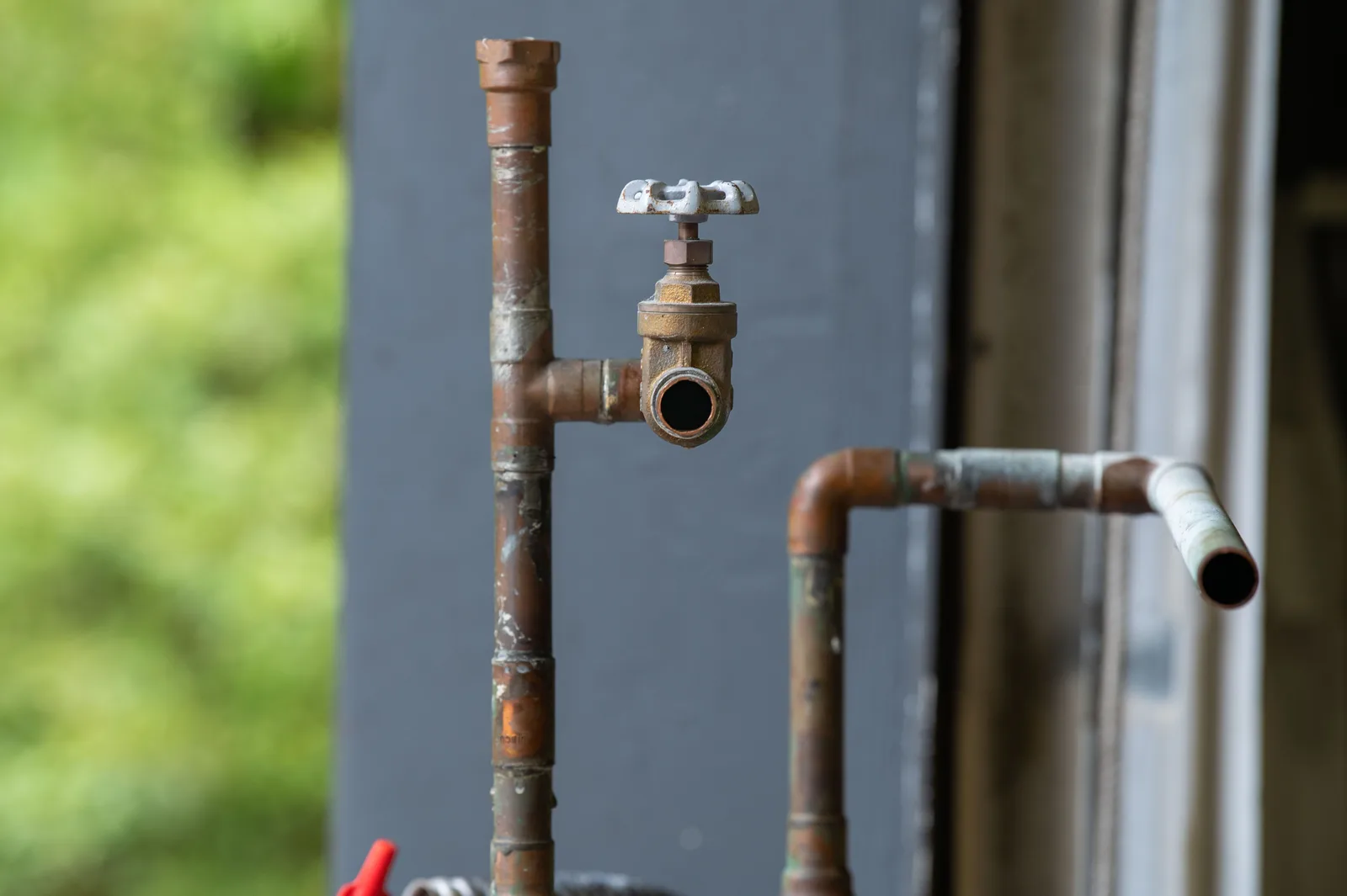 Aging copper supply line exposed during a plumbing repair