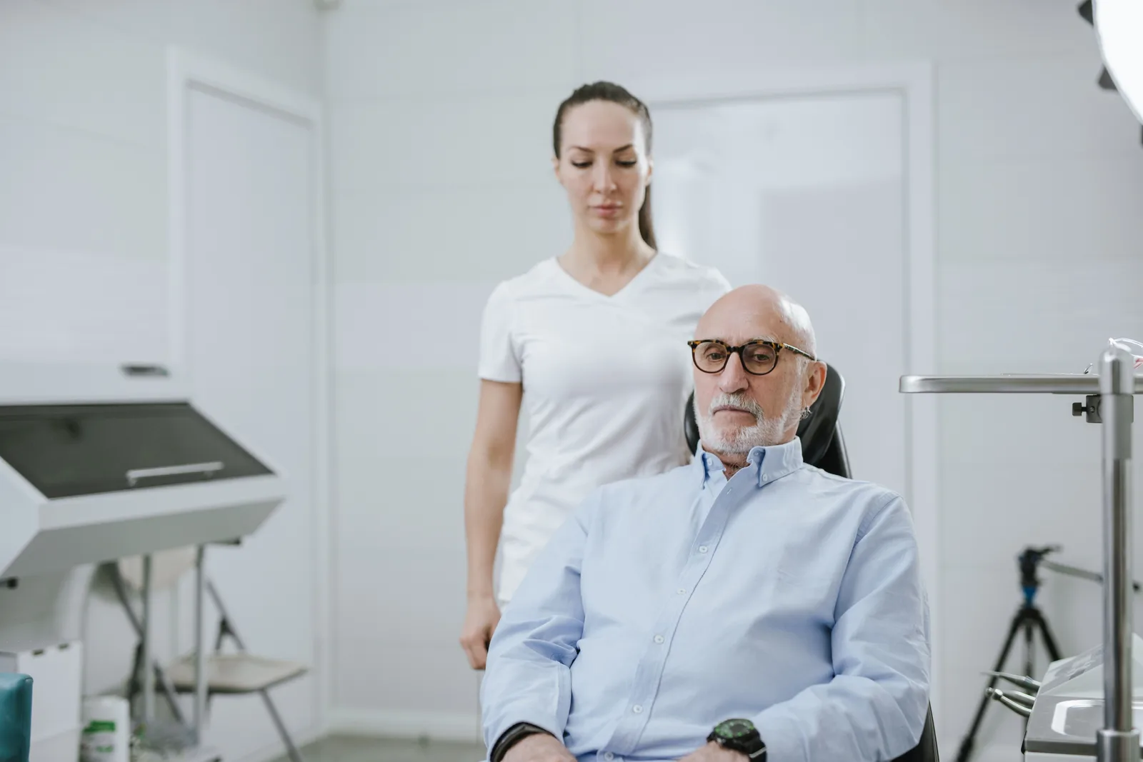 Clinician consulting with an older patient in an exam room