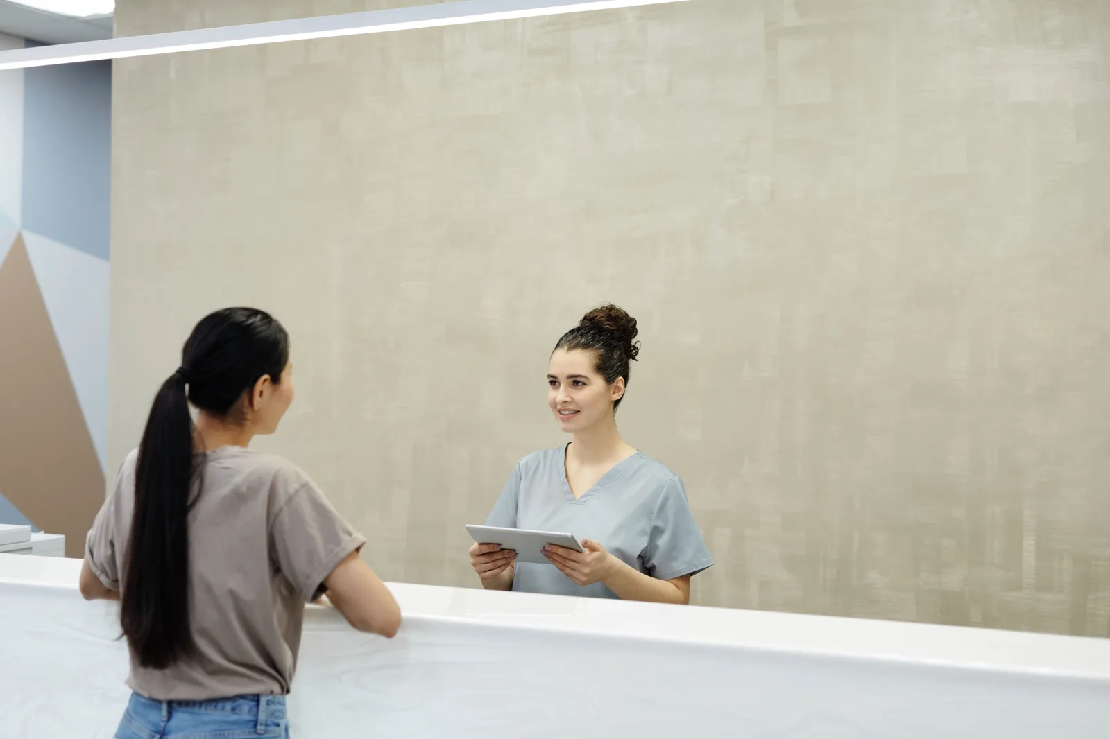 Patient checking in at a medical practice front desk
