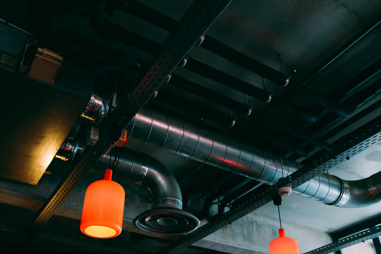 HVAC technician working on commercial ceiling ductwork installation