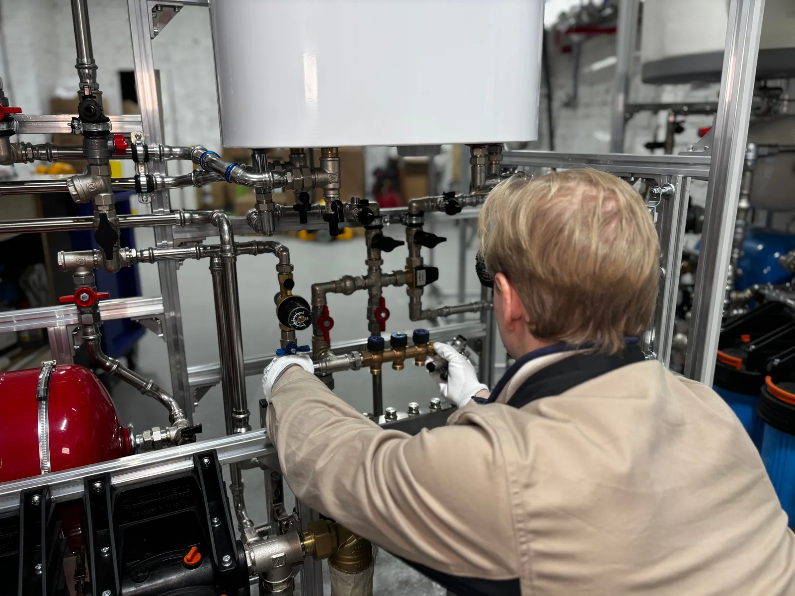 HVAC technician working on heating plant pipework