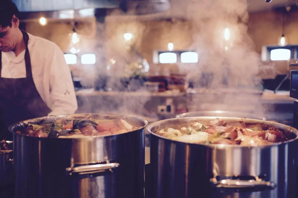 Line cook preparing ingredients before dinner service