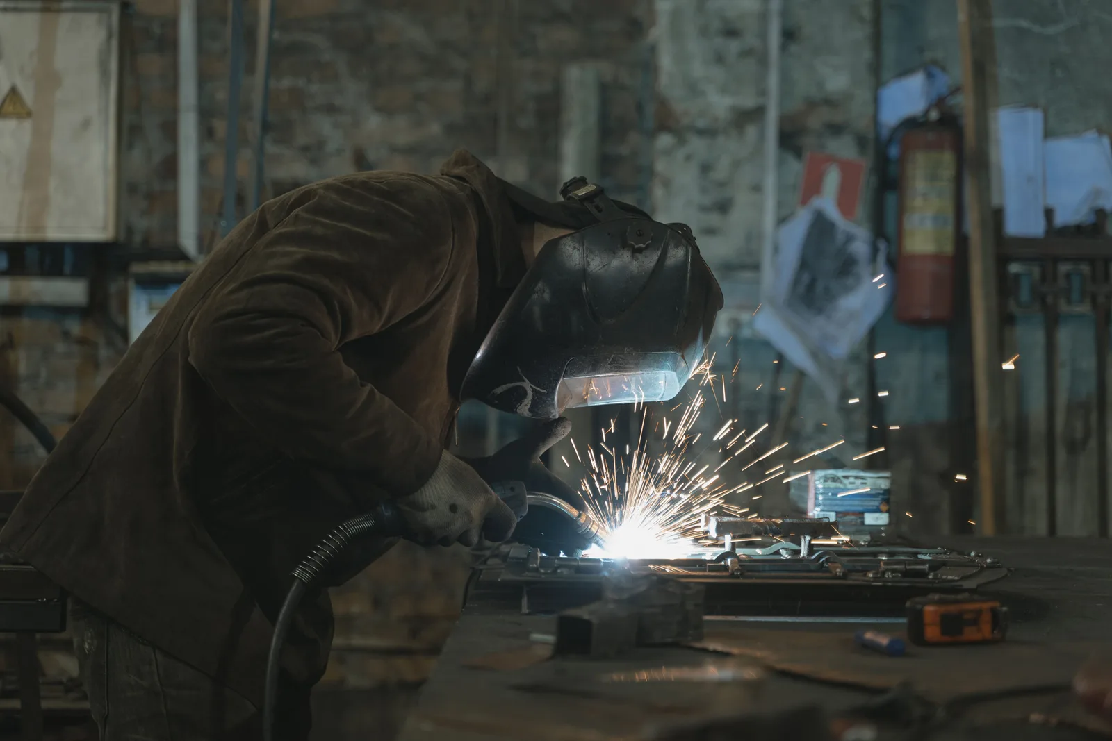 A welder mid-job in a workshop