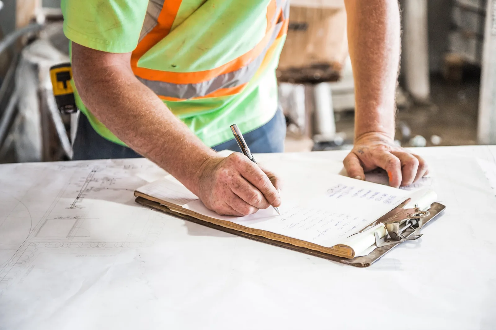 A worker filling in a form on a clipboard