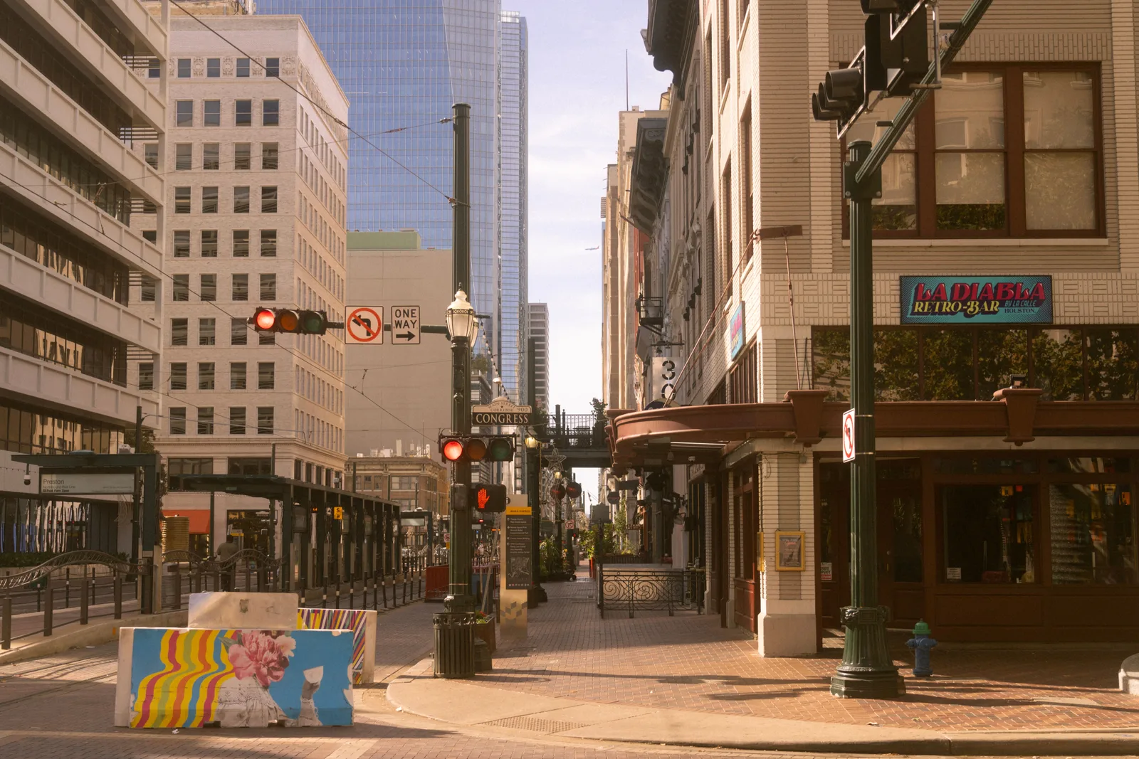 A corner in downtown Houston with street art and historic architecture