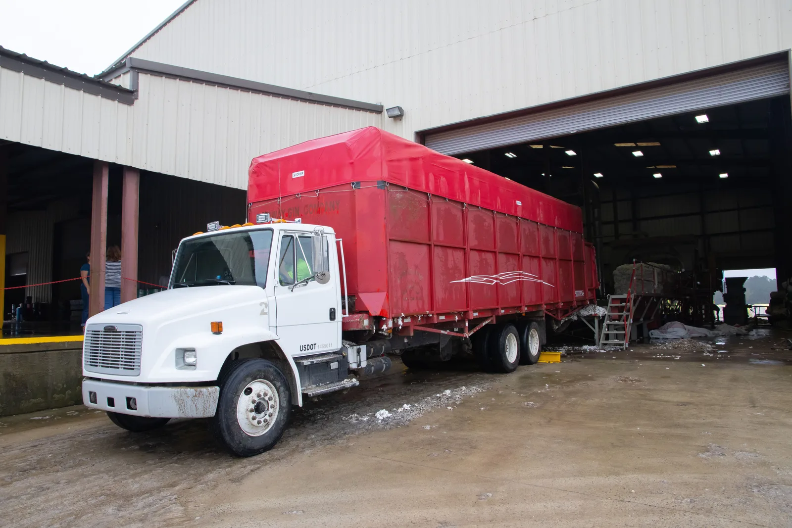 A freight trailer backed up to a loading dock
