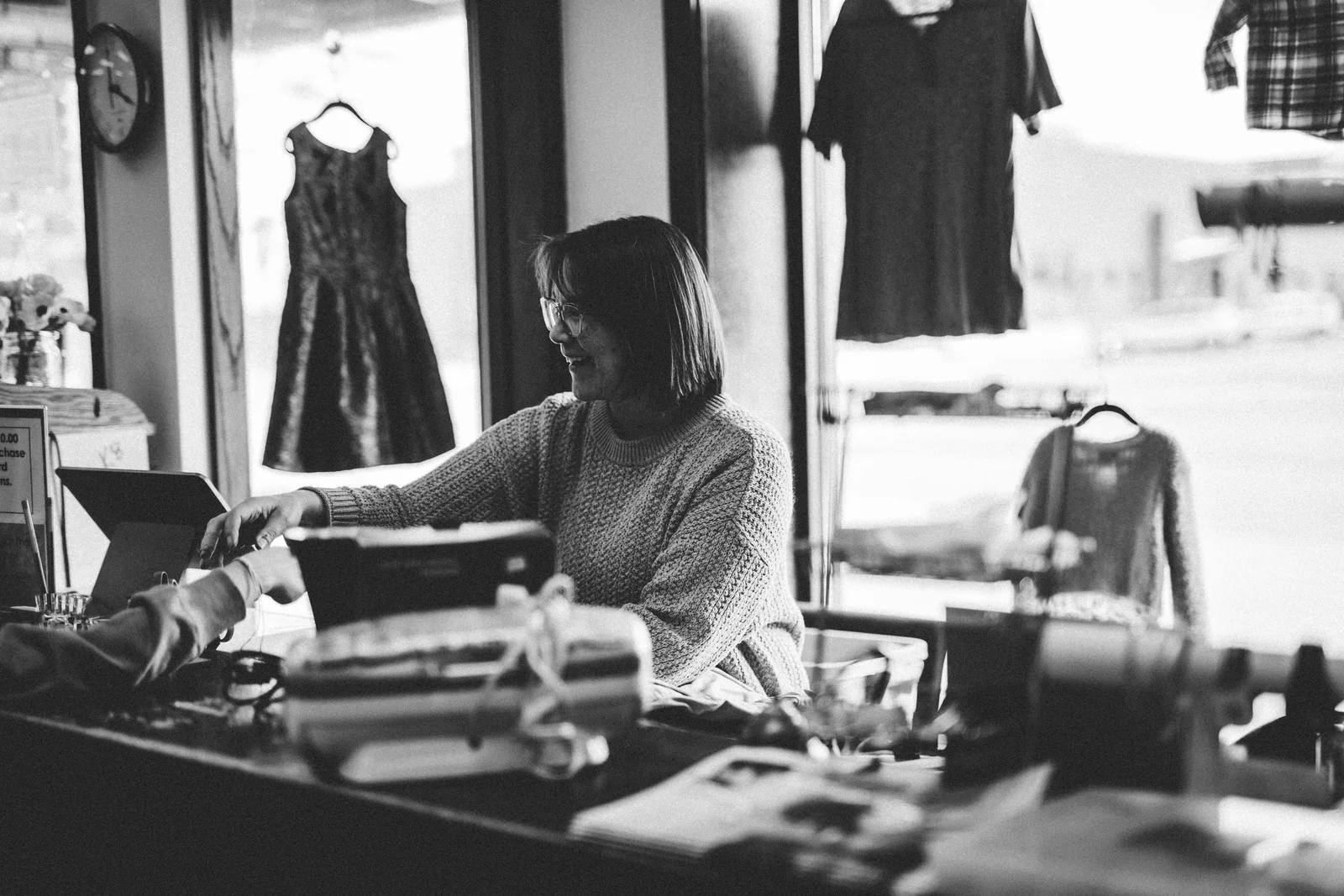 A shop worker serving a customer at a store counter