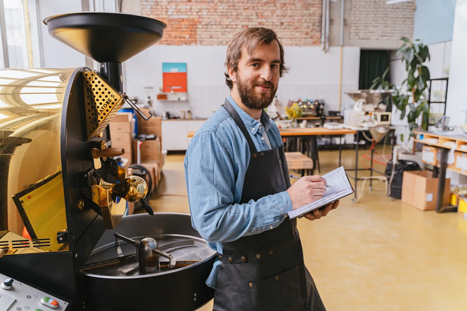A business owner taking notes while working through financial records