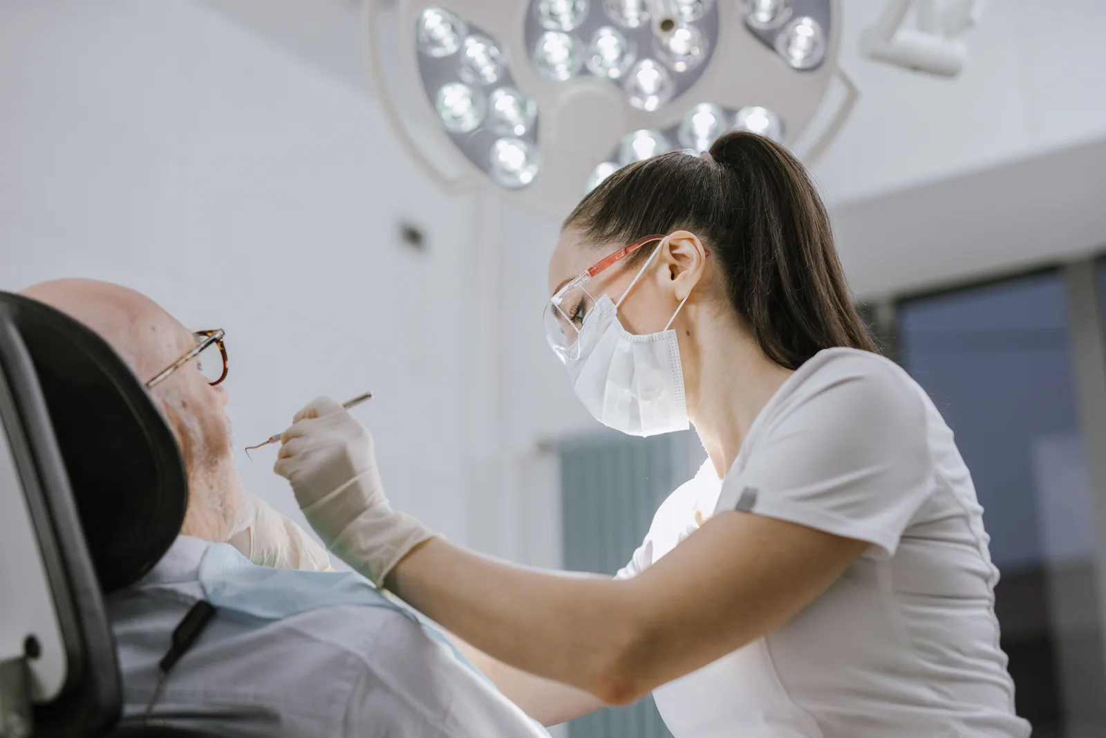 A dentist treating a patient in a dental practice