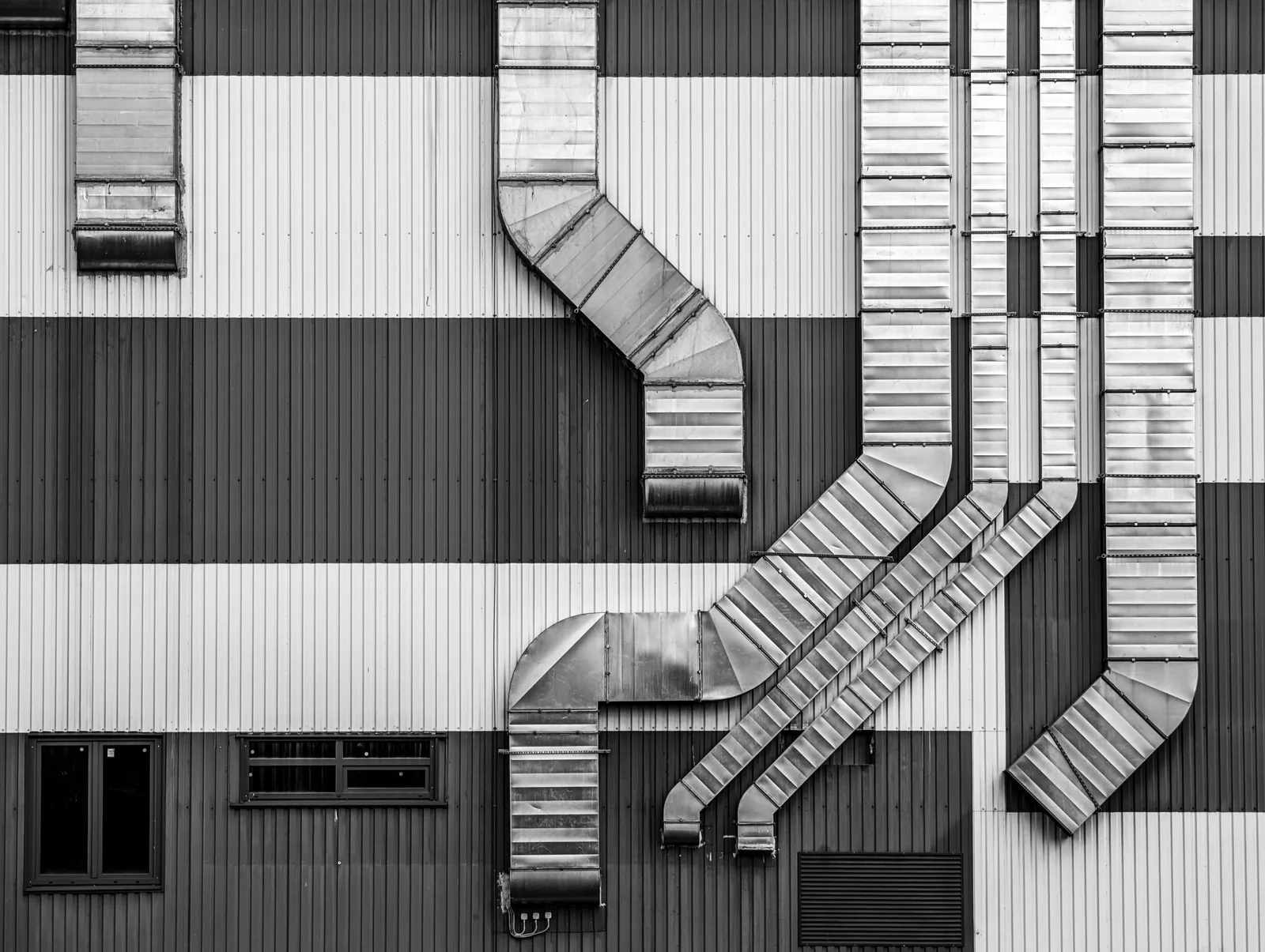 Exterior HVAC duct runs on a commercial building