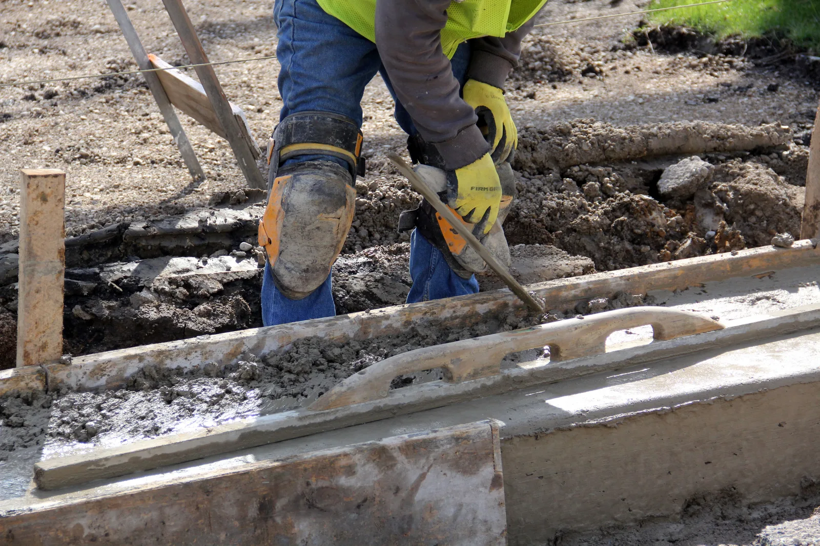 Worker trowel finishing a concrete flatwork pour