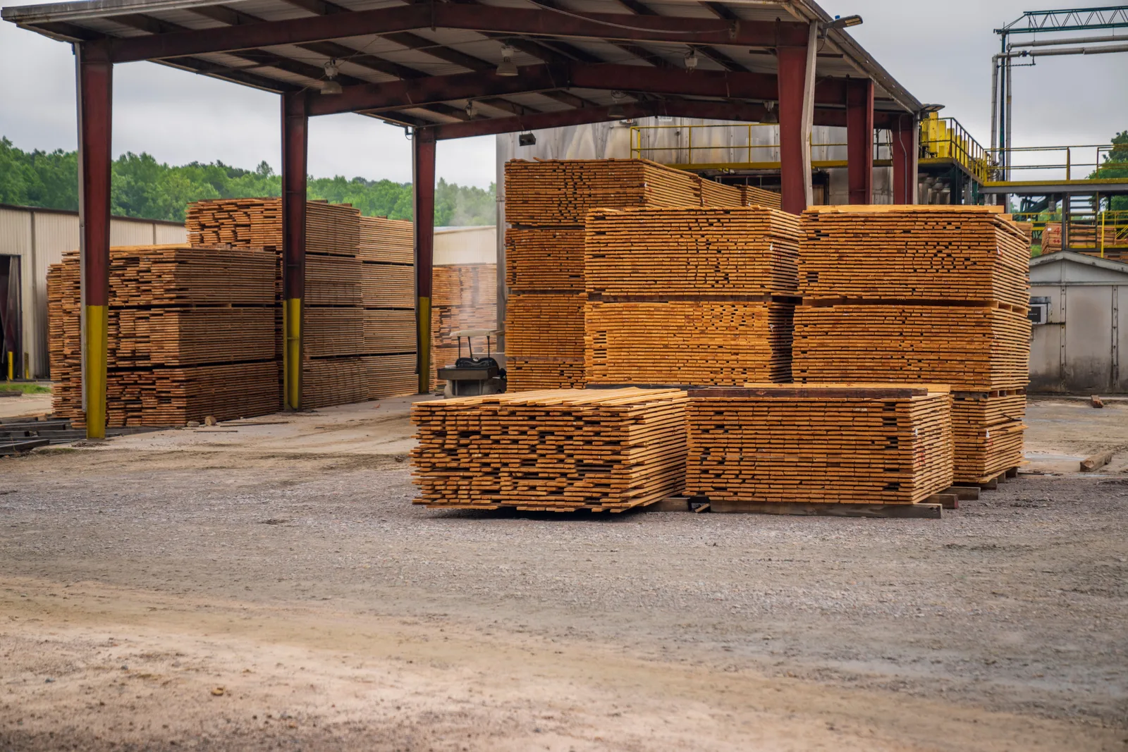 Stacks of lumber and building material staged at a jobsite yard