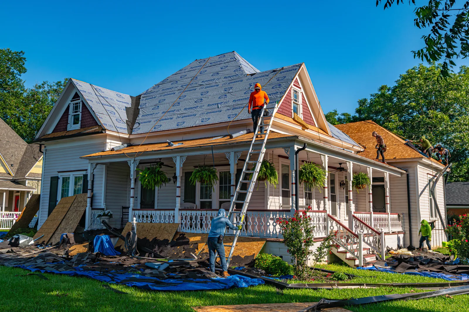 Roofing crew re-roofing an older home