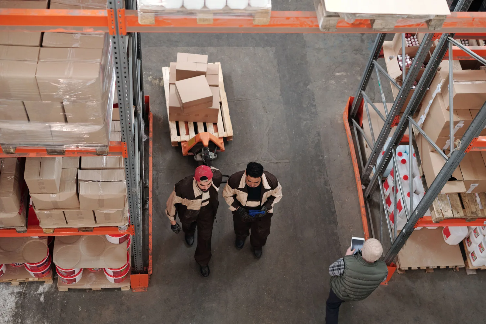 Warehouse workers preparing boxes and pallets for outbound shipment