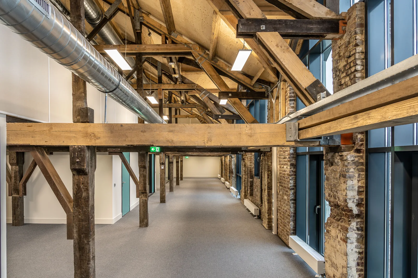 Spiral metal ductwork running the length of a finished commercial interior