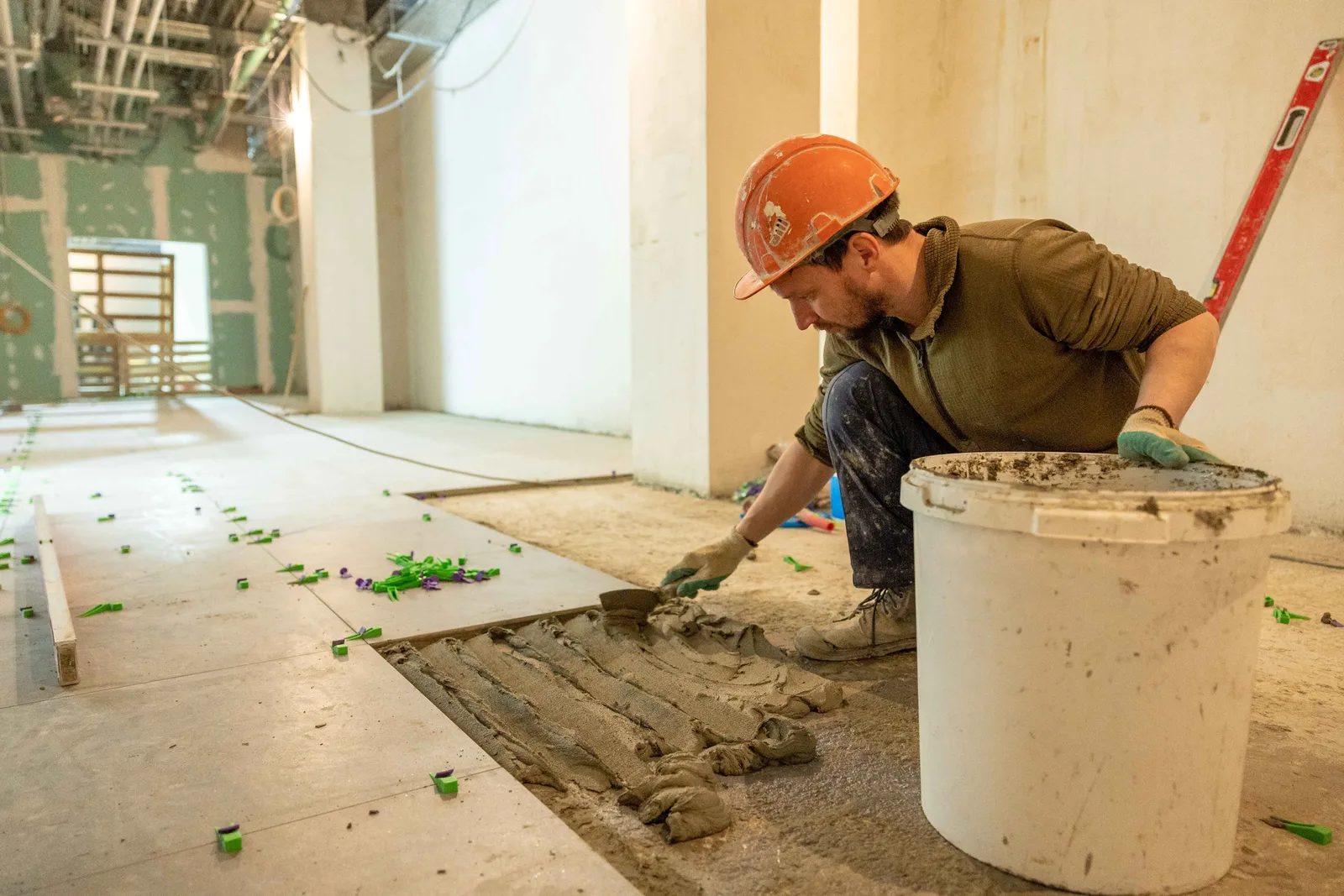 Tile setter completing an interior finish installation